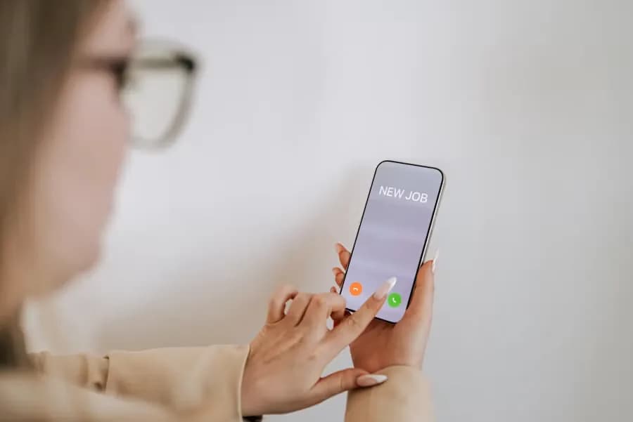 A caregiver answering an incoming call on her own mobile phone